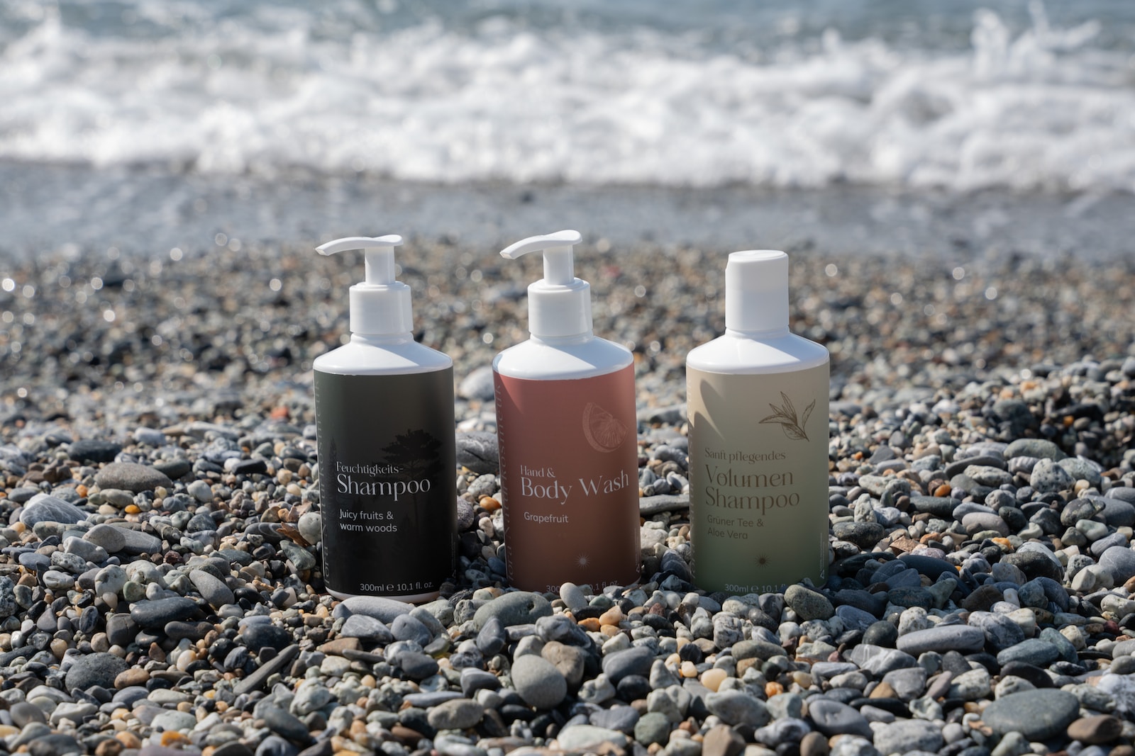 a group of bottles on a rocky beach